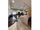 Bright kitchen with white cabinets, stainless steel appliances, brown countertops, and doorway to the front of the house at 114 N Arcturas Ave, Clearwater, FL 33765