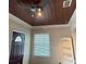 Interior view with dark wood ceiling and trim, a ceiling fan, and a partially visible doorway at 114 N Arcturas Ave, Clearwater, FL 33765
