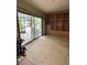 Bright room features sliding glass door to patio, custom bookcase and ladder at 114 N Arcturas Ave, Clearwater, FL 33765