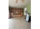 Spacious living room with built in bookshelves with ladder and a view of the hallway at 114 N Arcturas Ave, Clearwater, FL 33765