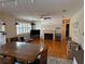 Spacious living room featuring hardwood floors, large windows with shutters, and a cozy fireplace at 114 N Arcturas Ave, Clearwater, FL 33765
