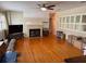 Hardwood floors, fireplace, and large windows with shutters define the spacious living room area at 114 N Arcturas Ave, Clearwater, FL 33765