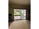 Living room features sliding glass door to a screened patio with a washing machine at 114 N Arcturas Ave, Clearwater, FL 33765