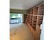 Spacious living room with sliding glass door to patio and custom bookshelf with ladder at 114 N Arcturas Ave, Clearwater, FL 33765