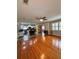 Spacious living room flows into the kitchen with hardwood flooring and natural light at 114 N Arcturas Ave, Clearwater, FL 33765