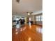 Spacious living room and kitchen combo with gleaming hardwood floors and natural light at 114 N Arcturas Ave, Clearwater, FL 33765