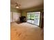 Living room features sliding glass door to screened patio, double closet, and custom shelving at 114 N Arcturas Ave, Clearwater, FL 33765