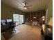 Home office featuring carpeted floors, built-in shelving, and sliding glass doors to backyard at 114 N Arcturas Ave, Clearwater, FL 33765