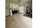 View of the room shows green walls and carpet with a few furnishings at 114 N Arcturas Ave, Clearwater, FL 33765