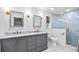 Modern bathroom with dual sinks, gray cabinetry, and a glass-enclosed shower at 1251 Fairway Dr, Dunedin, FL 34698