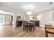 Inviting dining room features hardwood floors, a modern chandelier, and transitional decor with art at 1251 Fairway Dr, Dunedin, FL 34698