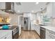 Bright kitchen featuring stainless steel appliances, white cabinets, and butcher block countertops at 1251 Fairway Dr, Dunedin, FL 34698