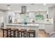 Modern kitchen with white cabinets, stainless steel appliances, large island, and barstool seating at 1251 Fairway Dr, Dunedin, FL 34698