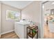 Functional laundry room with washer, dryer, and natural light from the window at 1251 Fairway Dr, Dunedin, FL 34698