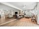 Open-concept living room with hardwood floors, large windows, and neutral decor at 1251 Fairway Dr, Dunedin, FL 34698