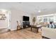 Cozy living room showcasing hardwood floors, fireplace, ceiling fan, and comfortable seating area at 1251 Fairway Dr, Dunedin, FL 34698