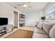 Inviting living room with tile floors, a comfy sofa, and an entertainment center, perfect for relaxation at 1251 Fairway Dr, Dunedin, FL 34698