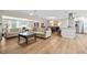 Open-concept living room featuring hardwood floors, neutral walls, and modern furnishings with great natural light at 1251 Fairway Dr, Dunedin, FL 34698