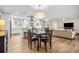 Stylish, open-concept living space with hardwood floors connecting living room, kitchen and dining area at 1251 Fairway Dr, Dunedin, FL 34698