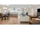 Bright, open-concept living space with hardwood floors, modern furniture, and an integrated kitchen at 1251 Fairway Dr, Dunedin, FL 34698