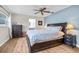 Comfortable main bedroom featuring a ceiling fan, hardwood floors, and neutral walls at 1251 Fairway Dr, Dunedin, FL 34698