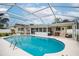 Inviting pool and patio area with an outdoor dining set, perfect for entertaining guests at 1251 Fairway Dr, Dunedin, FL 34698