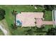 Aerial view of a single Gathering home featuring a private pool, tile roof, and lush landscaping at 12713 Grand Traverse Dr, Dade City, FL 33525