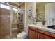 Bathroom featuring a glass-door shower, toilet, sink with vanity, and decorative wall art at 12713 Grand Traverse Dr, Dade City, FL 33525