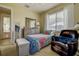 Cozy bedroom with a large window, dresser, and chair providing lots of natural light at 12713 Grand Traverse Dr, Dade City, FL 33525