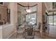 Charming breakfast nook with glass table set with views of the enclosed swimming pool at 12713 Grand Traverse Dr, Dade City, FL 33525