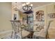 Formal dining area showcases chandelier, glass-top table and seamless flow to kitchen and living room at 12713 Grand Traverse Dr, Dade City, FL 33525