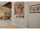 Well-appointed dry bar with storage, granite countertop, and seamless access to living area at 12713 Grand Traverse Dr, Dade City, FL 33525