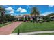 Lovely single-story home showcasing lush landscaping, beautiful lawn, tile roof, and a brick driveway leading up to the property at 12713 Grand Traverse Dr, Dade City, FL 33525