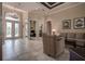 Welcoming foyer with decorative glass doors, soaring ceilings, and views into adjacent rooms at 12713 Grand Traverse Dr, Dade City, FL 33525