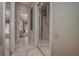 Hallway featuring mirrored closet doors and an arched doorway leading to the main bedroom and ensuite bath at 12713 Grand Traverse Dr, Dade City, FL 33525