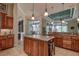 Spacious kitchen features a center island, stainless appliances, and seamless access to dining area at 12713 Grand Traverse Dr, Dade City, FL 33525
