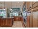Gourmet kitchen featuring stainless steel appliances, custom cabinetry, and large center island at 12713 Grand Traverse Dr, Dade City, FL 33525