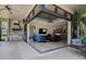 An open living area seamlessly connects indoor and outdoor spaces with tile flooring and neutral tones at 12713 Grand Traverse Dr, Dade City, FL 33525
