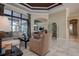 Bright living room with tile floors, neutral walls, tray ceiling, furniture, and decorative shelving and archways at 12713 Grand Traverse Dr, Dade City, FL 33525