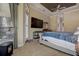 Comfortable main bedroom with tray ceiling, TV, and a view to the outside, designed for relaxation at 12713 Grand Traverse Dr, Dade City, FL 33525