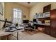 Office with a large window and a desk surrounded by cluttered supplies and furniture at 12713 Grand Traverse Dr, Dade City, FL 33525