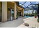 Expansive screened lanai with a pool view, ample patio space, and access to an outdoor kitchen area at 12713 Grand Traverse Dr, Dade City, FL 33525