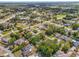 Aerial view of the neighborhood, showcasing the lush greenery and mature trees that surround the homes at 13991 Coronado Dr, Spring Hill, FL 34609