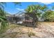Backyard with a screened-in pool area and well-maintained landscaping at 13991 Coronado Dr, Spring Hill, FL 34609