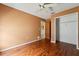 Bedroom featuring wood floors, closet, and doorway to an adjacent room at 13991 Coronado Dr, Spring Hill, FL 34609