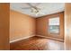 Bedroom featuring wood floors, a ceiling fan, and a window with blinds at 13991 Coronado Dr, Spring Hill, FL 34609
