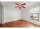 Bedroom featuring wood floors, a ceiling fan, and a window with blinds at 13991 Coronado Dr, Spring Hill, FL 34609