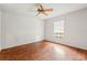 Bedroom featuring wood floors, a ceiling fan, and a window with blinds at 13991 Coronado Dr, Spring Hill, FL 34609