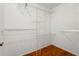 Empty walk-in closet with wire shelving, storage space, and wood floor at 13991 Coronado Dr, Spring Hill, FL 34609
