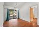 Dining room with hardwood floors and access to kitchen and backyard at 13991 Coronado Dr, Spring Hill, FL 34609